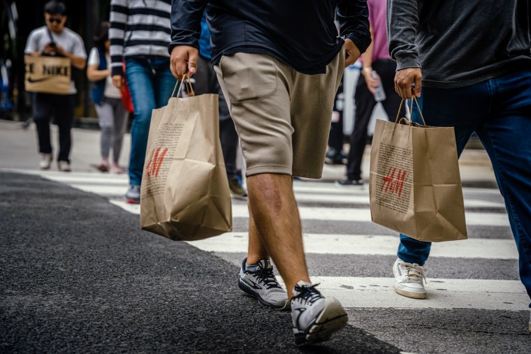 Shoppers carry retail bags along the Magnificent Mile shopping district in Chicago on Aug. 15, 2023.