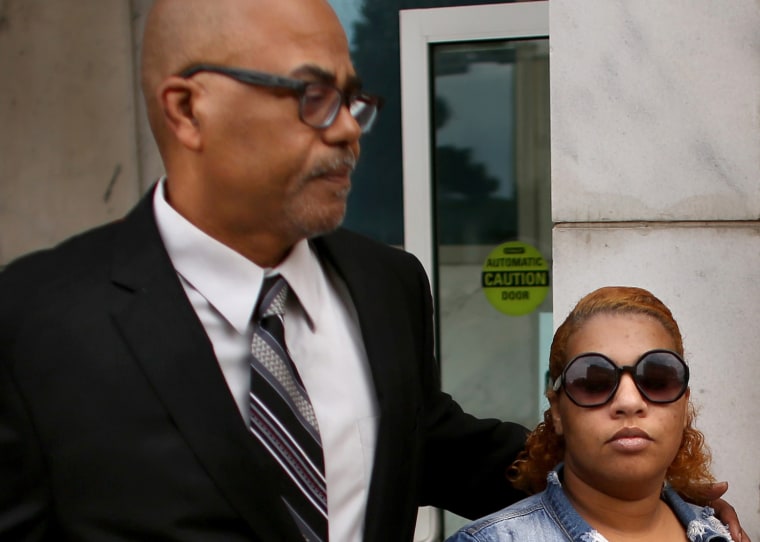 Deja Nicole Taylor, the mother of the 6-year-old shooter at Richneck Elementary School in Newport News, Virginia, is escorted out by her grandfather, Calvin Taylor, following her arraignment on April 14, 2023. 