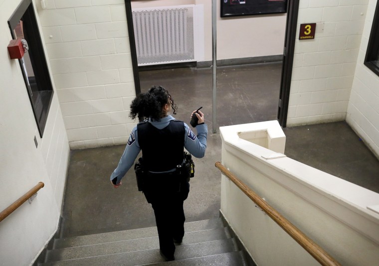 A Minneapolis Police officer and school resource officer does her rounds in the hallways at Roosevelt High School on Jan. 18, 2019.