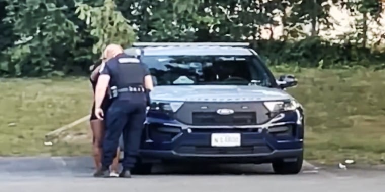 A Prince George County officer with a woman before going in the back seat of the patrol car.