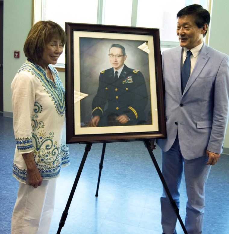 Dyanne McMath, niece of Col. Young-Oak Kim, and Woo Sung Han, award-winning journalist and author of Unsung Hero stand next to a portrait of the late Col. Young-Oak Kim after its unveiling at the Armed Forces Reserve Center at Camp Humphreys, South Ko