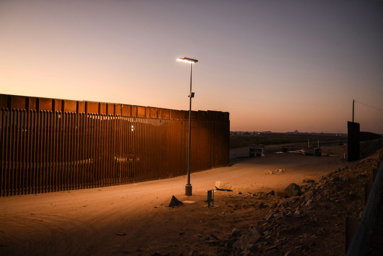 A gap in the border wall is illuminated at night between the U.S. and Mexico in Yuma, Ariz., on May 31, 2022.