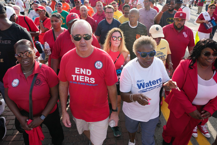 United Auto Workers President Shawn Fain, second from right, at Labor Day parade in Detroit on Sept. 4, 2023. 