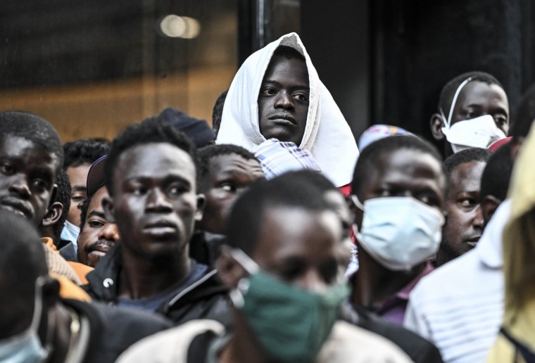 Migrants line up outside the Roosevelt Hotel while waiting for placement at a shelter in New York on Aug. 2, 2023. 