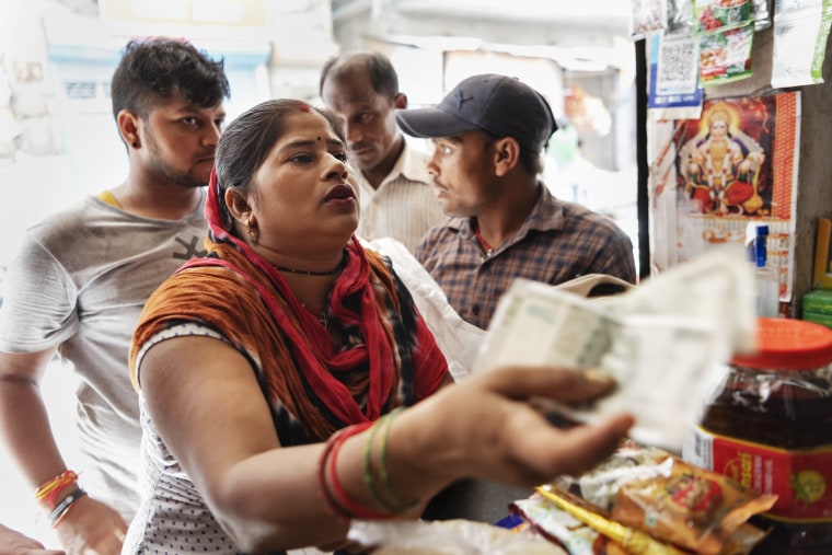 Raj Kumari, 30, shops for rations at a shop in New Delhi on Sept. 5, 2023.