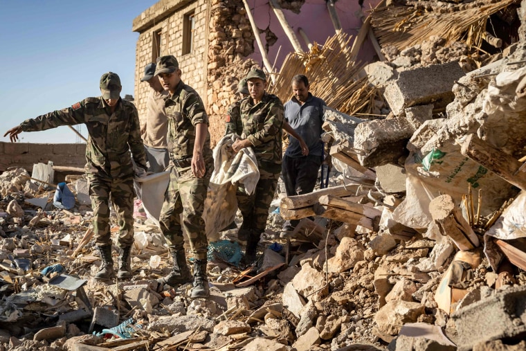Moroccan Royal Armed Forces evacuate a body from a house destroyed in an earthquake in the mountain village of Tafeghaghte, southwest of the city of Marrakech, on Sept. 9, 2023. 