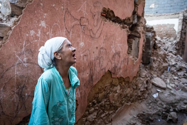 A woman reacts standing in front of her earthquake-damaged house in the old city in Marrakech on Sept. 9, 2023.