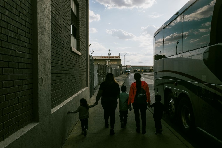 Migrants exit a bus after being released from federal immigration custody in El Paso, Texas, on May 16, 2023.