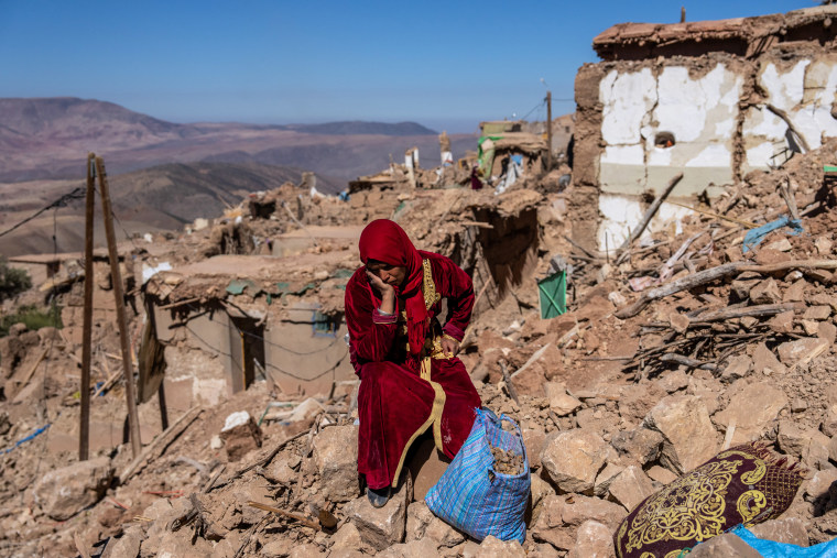 A woman sits amongst the rubble of her village in Douzrou, Morocco, on Sept. 11, 2023, that was almost completely destroyed by the earthquake three days earlier.