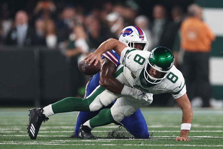 Aaron Rodgers of the New York Jets is sacked by defensive end Leonard Floyd of the Buffalo Bills on Sept. 11, 2023. 
