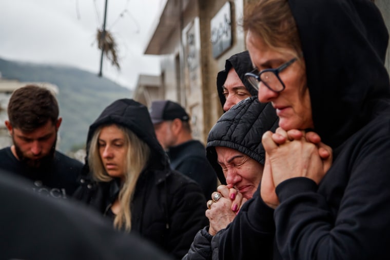 People mourn during the burial of a victim in Mucum, Rio Grande do Sul, Brazil, on Sept. 9, 2023.