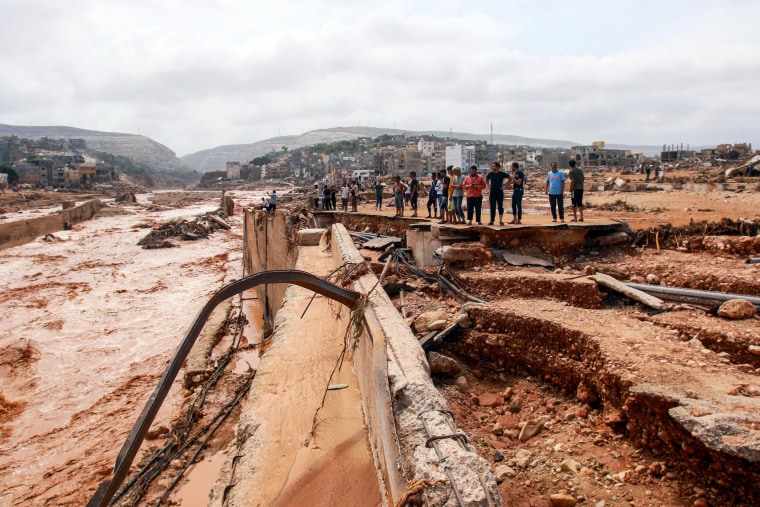 People look at the damage caused by freak floods in Derna, eastern Libya, on September 11, 2023. 