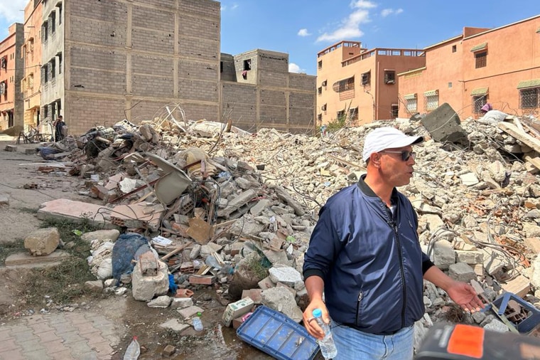 Ali stands in front of the rubble of the former Café Anmoggar in Amizmiz.