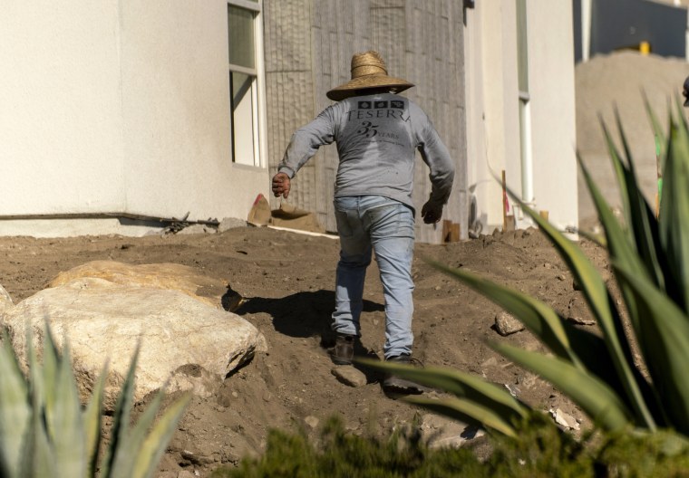 Image: A contractor works at an apartment complex in Palm Springs, Calif., on July 14.