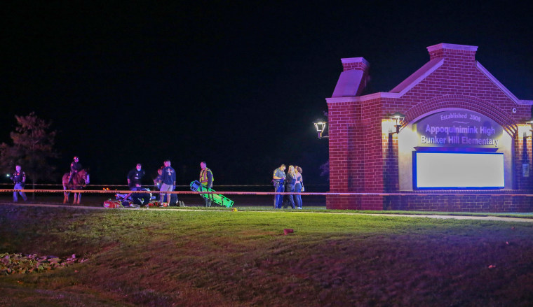 Emergency personnel treat a shooting victim near the entrance to the Appoquinimink High School campus as a football game between Middletown and Appoquinimink High Schools was ending on Sept 23, 2022, in Wilmington, Del.