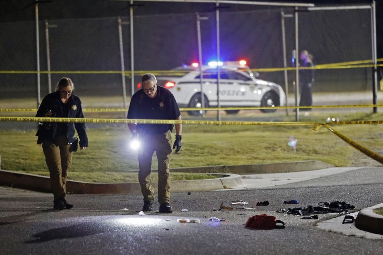 Police investigate the area outside of the McLain High School football stadium after a shooting during a football game on Sept. 30, 2022 in Tulsa, Okla. 
