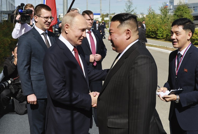 Russian President Vladimir Putin, left, and North Korea's leader Kim Jong Un shake hands during their meeting at the Vostochny spaceport outside the city of Tsiolkovsky, Russia, on Wednesday, Sept. 13, 2023. 