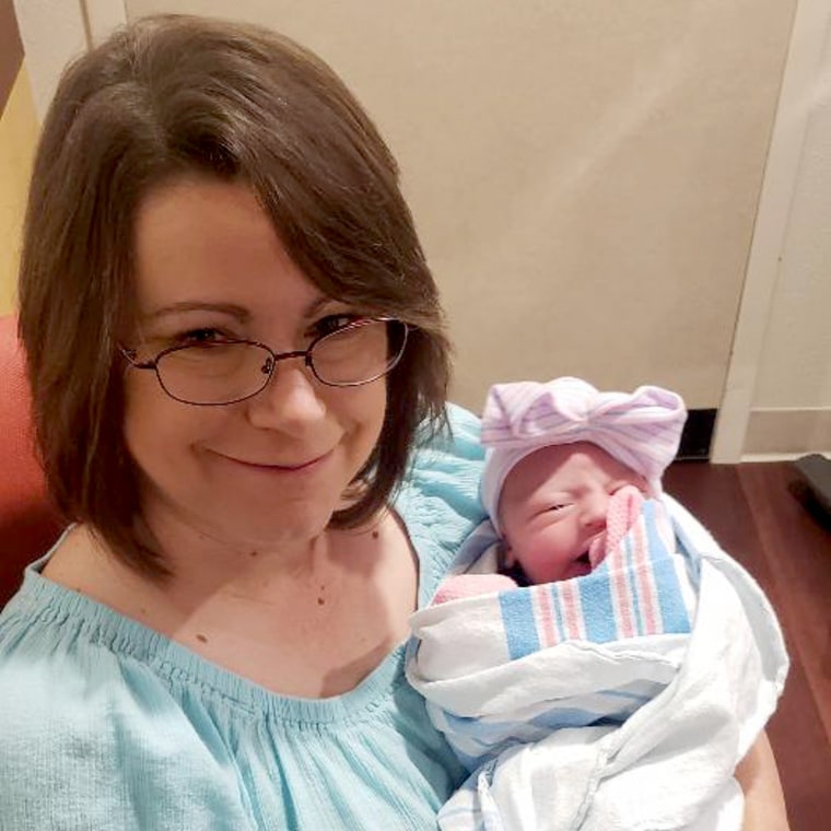 Image: Cathy Greninger holds her newborn granddaughter, Savannah.
