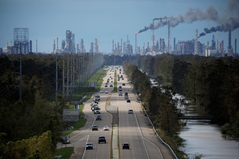 Traffic moves along a stretch of roads near the Royal Dutch Shell and Valero Energy's Norco refineries in LaPlace, La., in 2021.