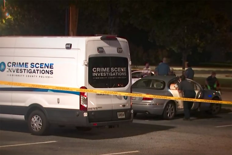 Gwinnett County Police investigate the crime scene where a body was found in a car in Duluth, Ga., on Sept 13, 2023.