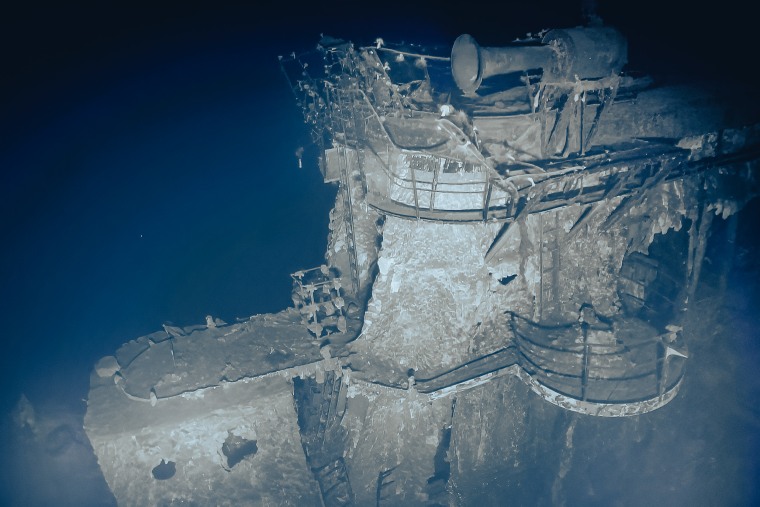 USS Yorktown 3: 
Standing tall above the leaning flight deck, the shipʻs island is the most prominent feature on USS Yorktown, heavily damaged by intense fire and heat. Photo captured by ROV Atalanta on September 9-10, 2023.