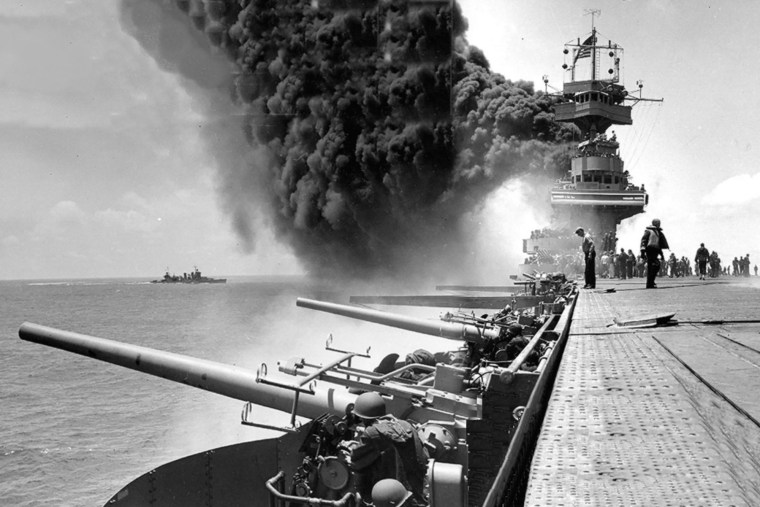 USS Yorktown (CV-5) burns after being hit by three Japanese bombs at the Battle of Midway, 4 June 1942.
