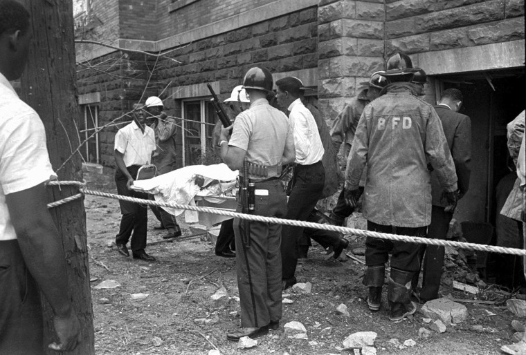 Firefighters and ambulance attendants remove a covered body from the 16th Street Baptist Church in Birmingham, Ala.