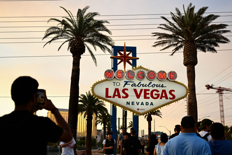 People take pictures with the "Welcome To Fabulous Las Vegas" sign on July 29, 2023.