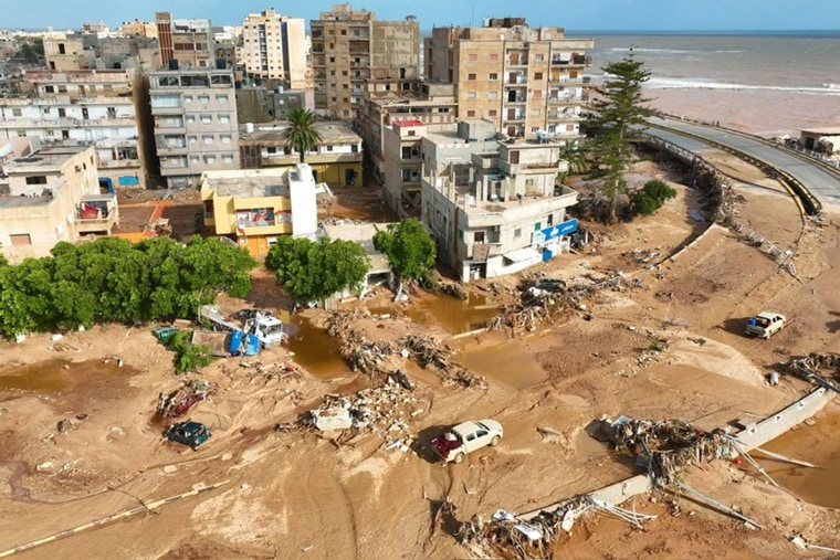 Downstream of the second dam, a wide torrent of water cascaded through the city center, smashing into buildings on either side.