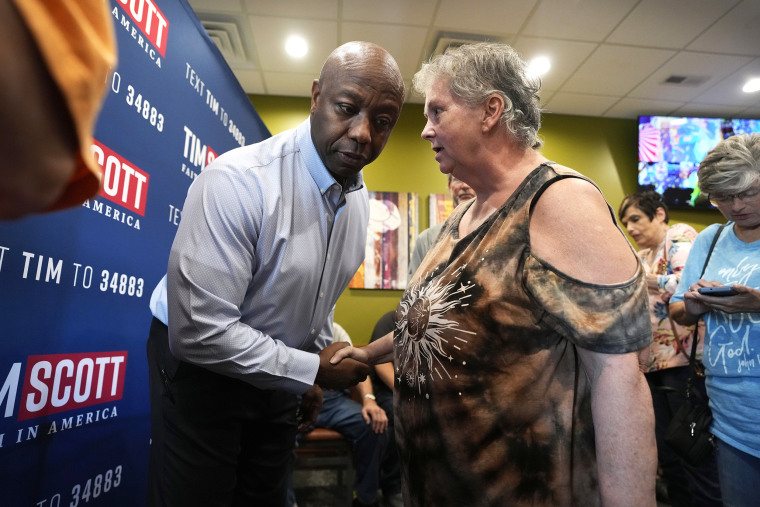 Republican presidential candidate Sen. Tim Scott, R-S.C., talks with an audience member during a meet and greet, Monday, Sept. 18, 2023, in Fort Dodge, Iowa.