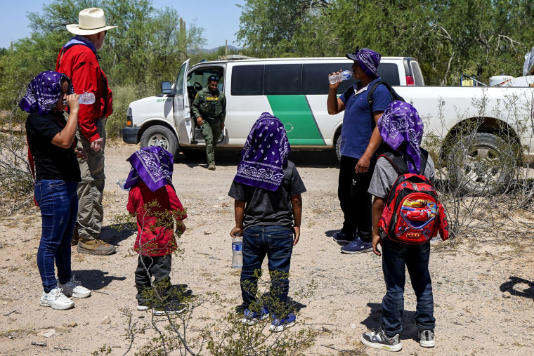 A U.S. Customs and Border Patrol agent arrives to pick up a family of five in the Tucson Sector of the U.S.-Mexico border