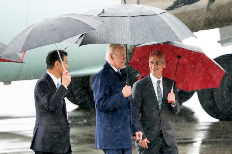 President Joe Biden, center, walks with Ambassador Rahm Emanuel, right, as he arrives at Marine Corps Air Station Iwakuni in  Japan, on May 18, 2023.