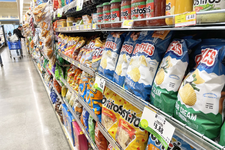 Sale priced potato chips are displayed at a grocery store on February 10, 2023 in San Anselmo, California. Super Bowl fans are seeing lower prices of their favorite game day foods like chicken wings and guacamole. Avocados are an estimated 20 percent cheaper than last year and the price of chicken wings is down nearly one dollar per pound.