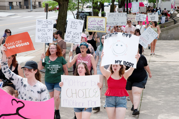 Protesters hold placards expressing their opinion at a pro abortion rights rally. People from many different cities gathered to support and rally for abortion rights. In light of the Supreme Court decision that could overturn Roe v. Wade that leaked roughly two weeks ago, hundreds of people in Dayton, spoke and marched for abortion access.