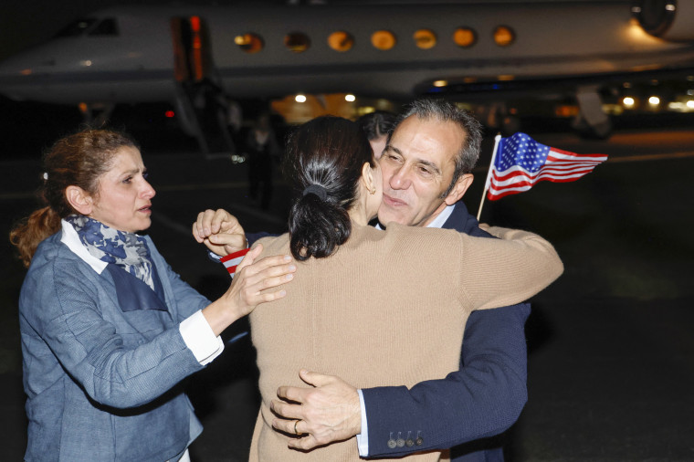 Family members embrace freed American Emad Shargi as he arrives at Davison Army Airfield at Fort Belvoir, Va., on Sept. 19, 2023.