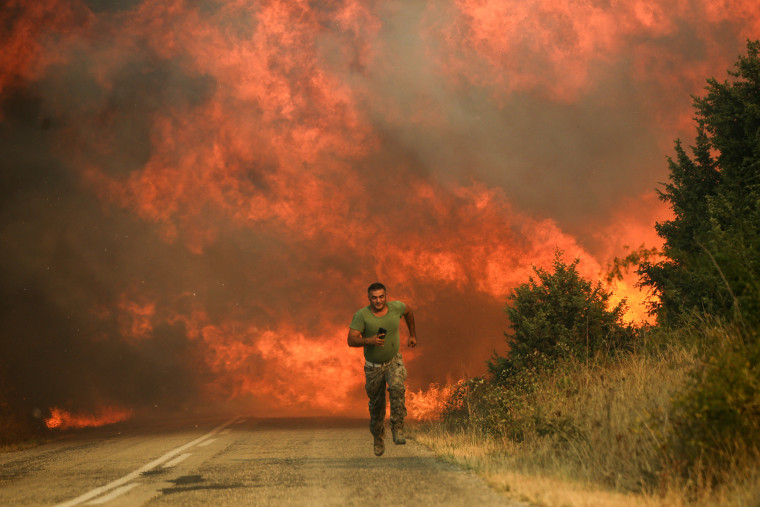 A firefighter runs as wildfire intensifies in Evros, Greece, on Aug. 31, 2023.