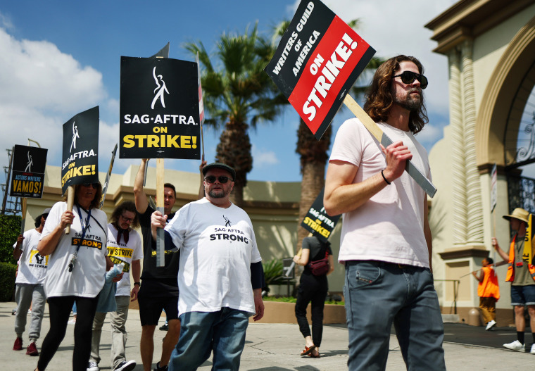 Striking members of WGA and SAG-AFTRA picket