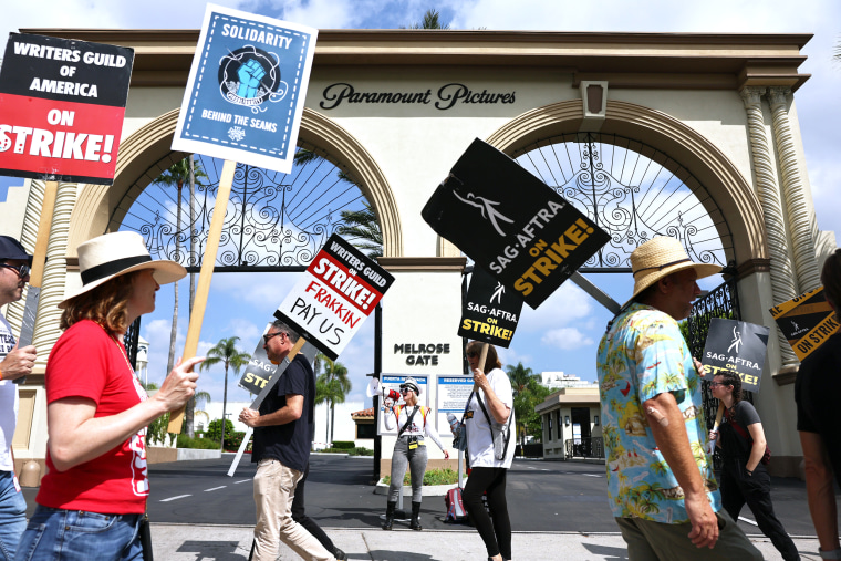 Striking members of WGA and SAG-AFTRA picket in Los Angeles