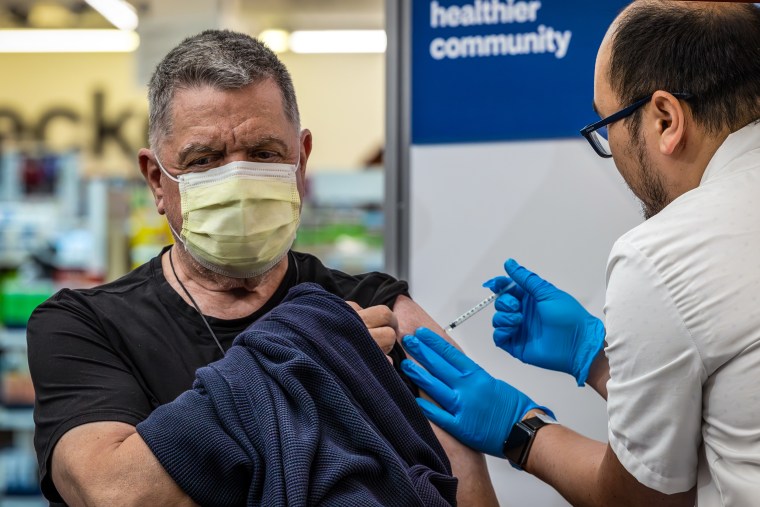 A pharmacist administers a new mRNA Covid vaccine COMIRNATY by Pfizer at CVS Pharmacy in Eagle Rock, Calif., on Sept. 14, 2023.