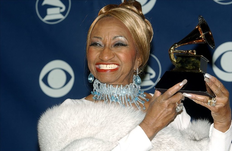 Celia Cruz holds her award for Best Salsa Album backstage at