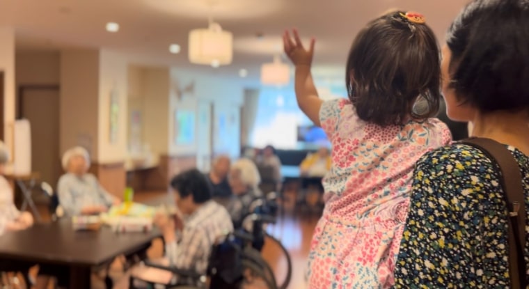 Rena waves goodbye at the end of a visit to the nursing home. 