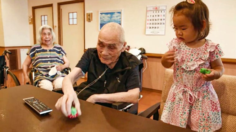 18-month-old Rena with residents at the Ichoan Nursing Home.