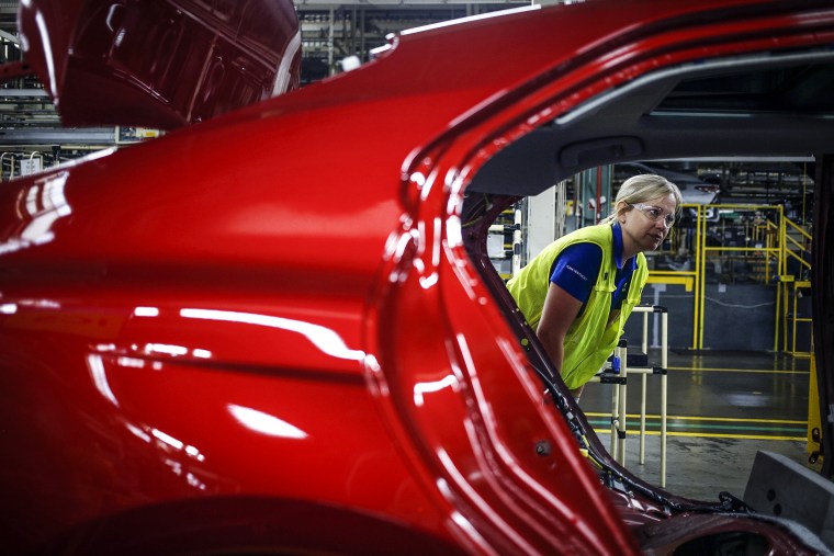 Plant Manager Susan Elkington looks over a Camry vehicle on an assembly line at the Toyota Motor Corp. manufacturing plant in Georgetown, Ky., on Aug. 29, 2019.