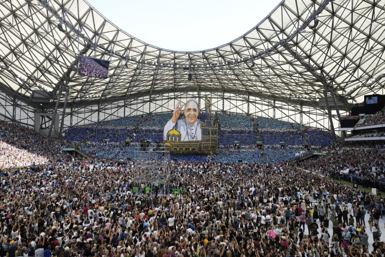 People wait for the arrival of Pope Francis at the Velodrome Stadium