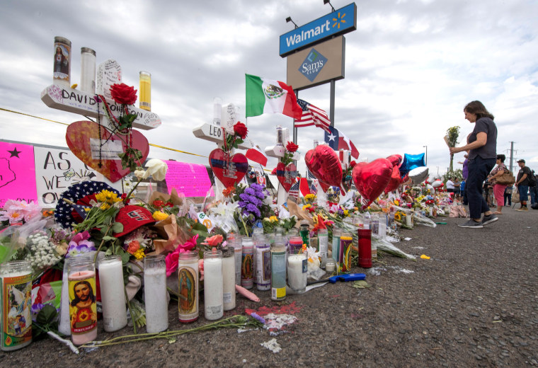 People leave flowers at a makeshift memorial for shooting victims at the Cielo Vista Mall Walmart, in El Paso, Texas