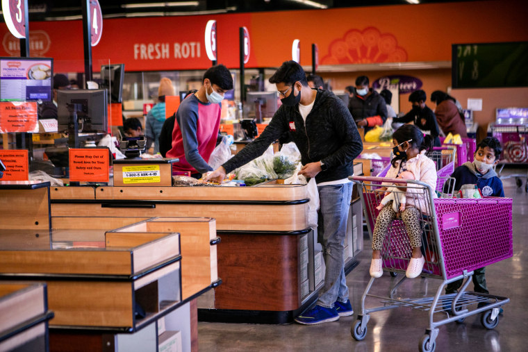People shop at the Pioneer Cash & Carry in the Little India neighborhood in Artesia, Calif., on Dec. 28, 2021.