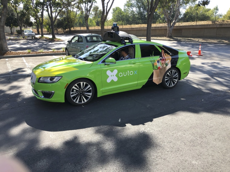 A Lincoln MKZ outfitted with AutoX's self-driving sensors sits in the parking lot of the company's headquarters in San Jose, Calif.