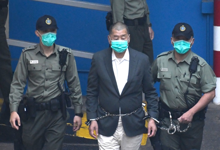 Jimmy Lai escorted by prison guards at Lai Chi Kok Reception Center in Hong Kong