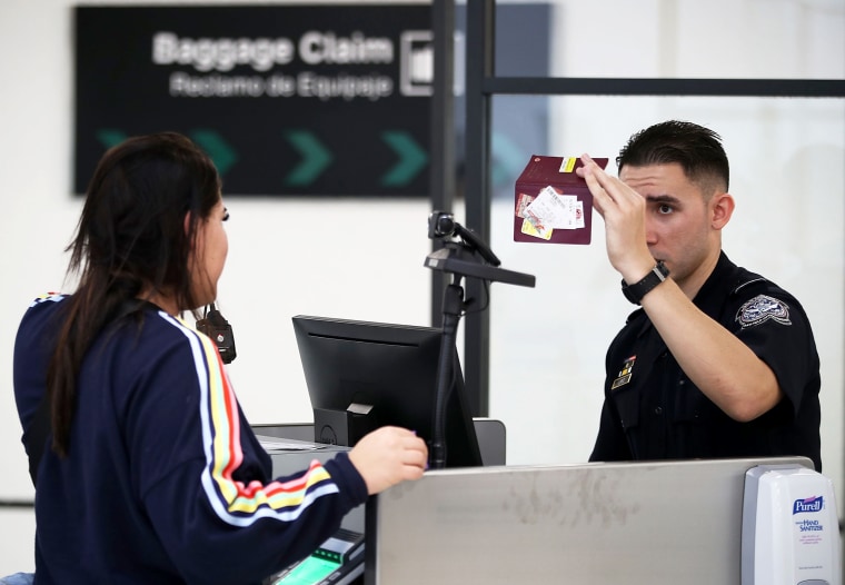 A U.S. Customs and Border Protection officer uses facial recognition technology in his booth at Miami International Airport to screen a traveler entering the United States on February 27, 2018 in Miami, Florida.  The facility is the first in the country that is dedicated to providing expedited passport screening via facial recognition technology, which verifies a traveler's identity by matching them to the document they are presenting.