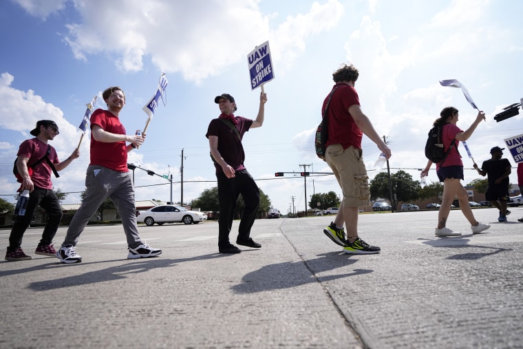 UAW union members picket in front of a Stellantis distribution center